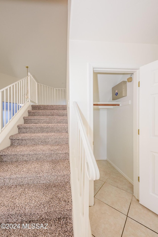 staircase featuring tile patterned floors