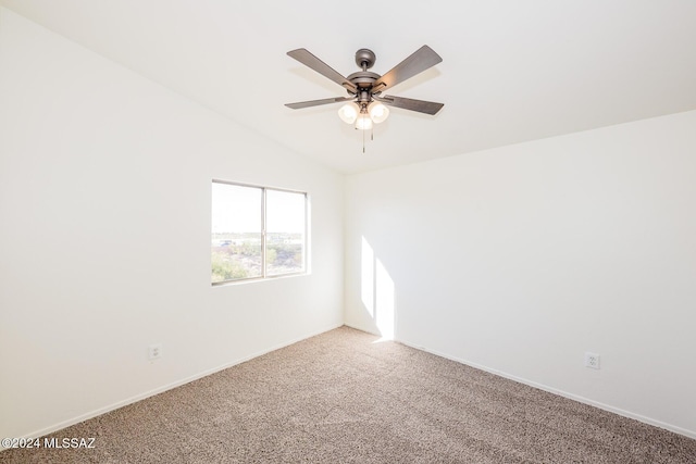 carpeted empty room featuring vaulted ceiling and ceiling fan