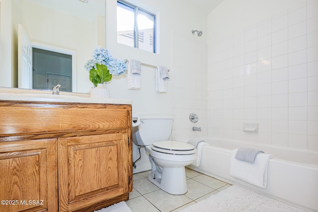 full bathroom featuring tile patterned flooring, vanity, tiled shower / bath combo, and toilet