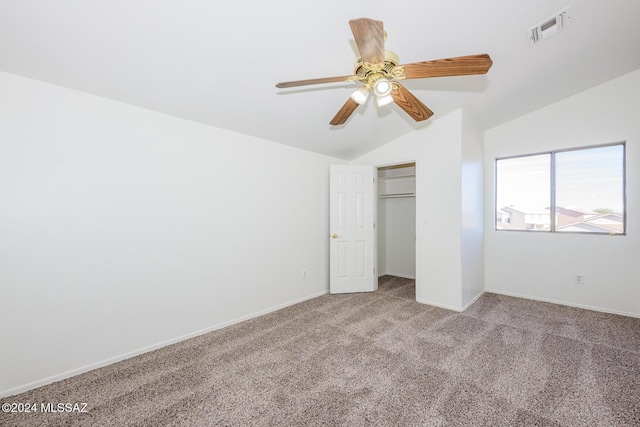 unfurnished bedroom with ceiling fan, a closet, light carpet, and vaulted ceiling