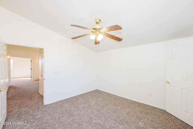 carpeted spare room with vaulted ceiling and ceiling fan