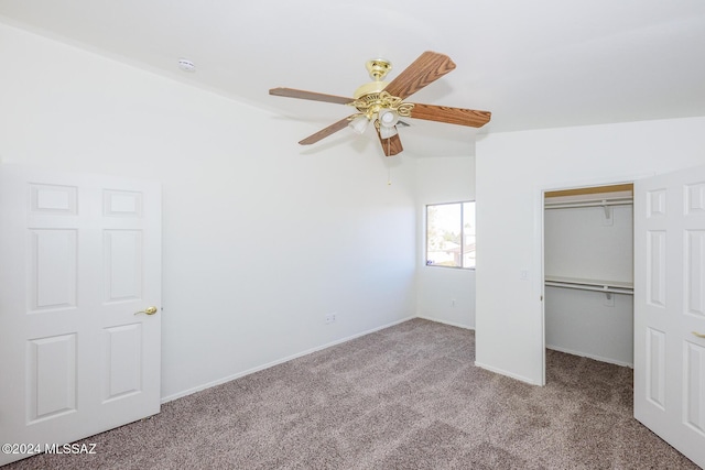 unfurnished bedroom featuring light carpet, a closet, ceiling fan, and lofted ceiling