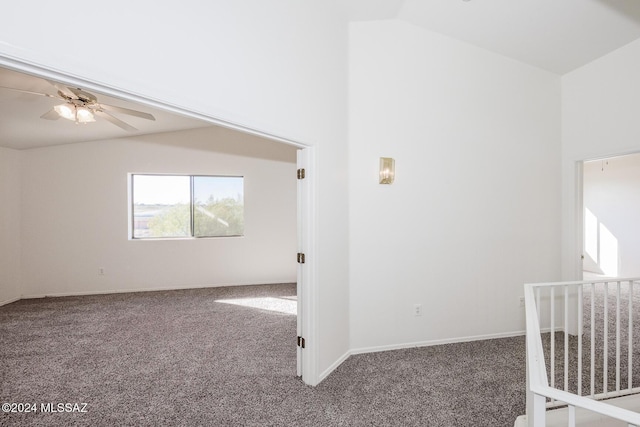 carpeted spare room featuring ceiling fan and vaulted ceiling