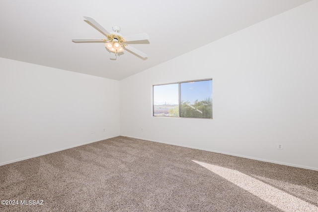 empty room featuring carpet, ceiling fan, and vaulted ceiling