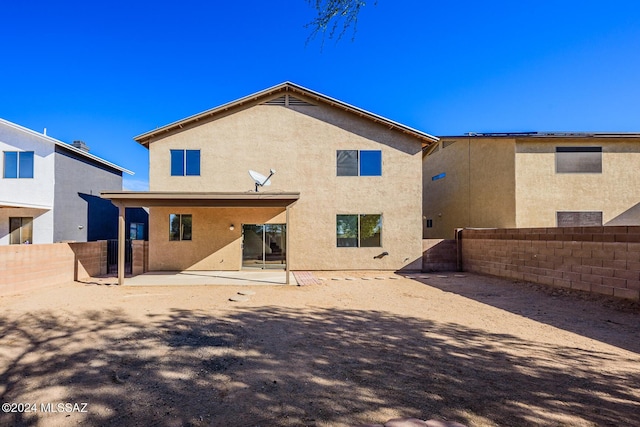 back of house with a patio