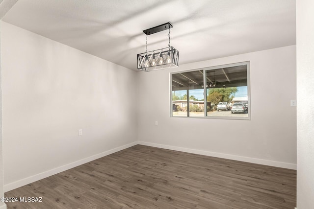 spare room with dark hardwood / wood-style flooring and a textured ceiling