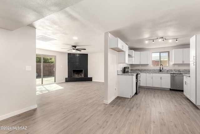 kitchen with appliances with stainless steel finishes, ceiling fan, sink, light hardwood / wood-style flooring, and white cabinetry