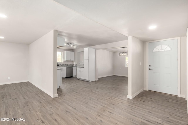 entryway featuring light hardwood / wood-style flooring, rail lighting, and sink