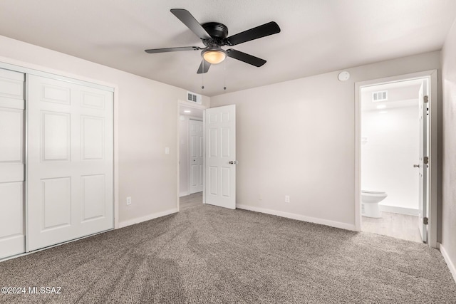 unfurnished bedroom featuring ceiling fan, a closet, carpet floors, and ensuite bathroom