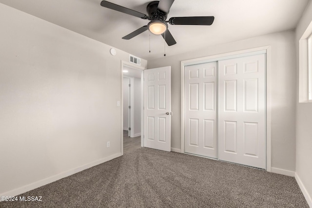 unfurnished bedroom with ceiling fan, a closet, and carpet floors