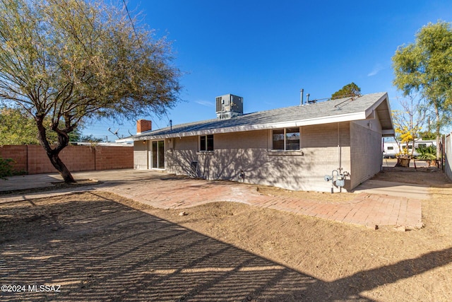 back of property featuring cooling unit and a patio