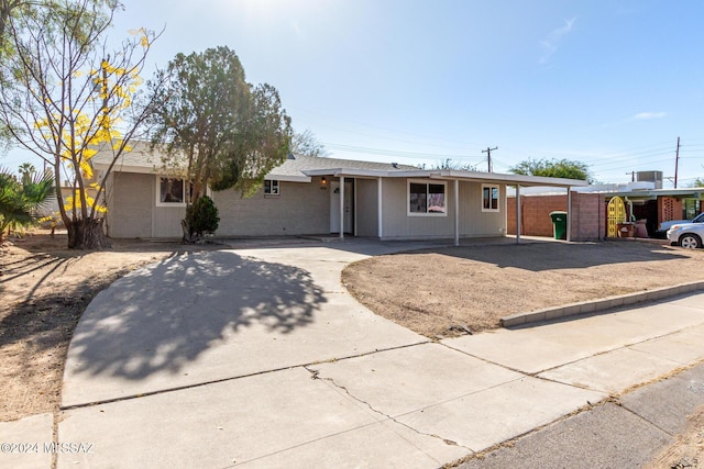 ranch-style home with a carport