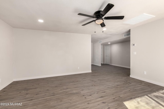 empty room featuring ceiling fan and dark hardwood / wood-style flooring