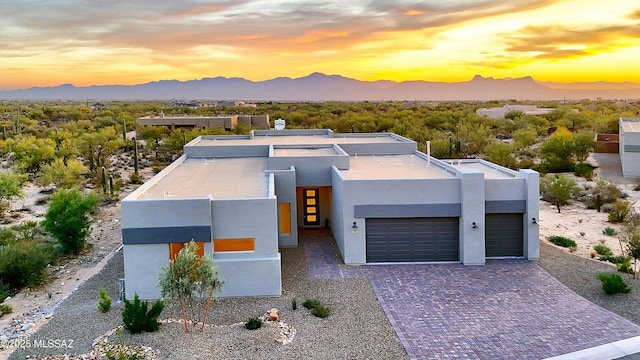 view of front of home with a mountain view and a garage