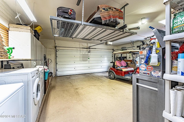 garage with a garage door opener and washer and clothes dryer