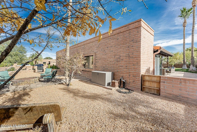 view of property exterior featuring central air condition unit and a patio