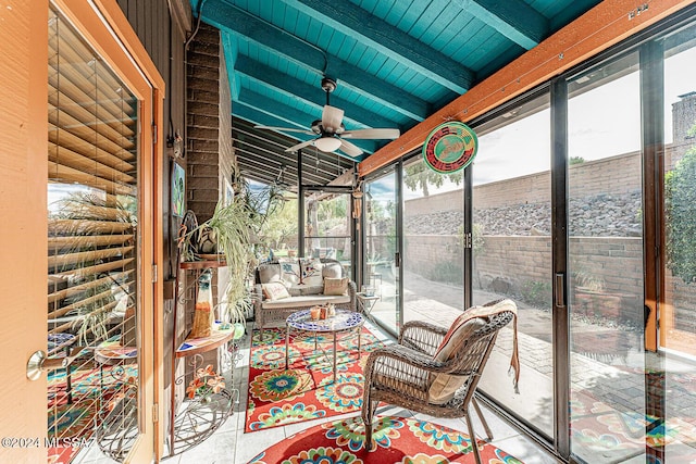 unfurnished sunroom with lofted ceiling with beams, ceiling fan, and wood ceiling