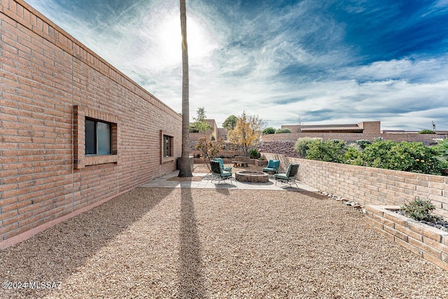 view of yard featuring a patio and an outdoor fire pit