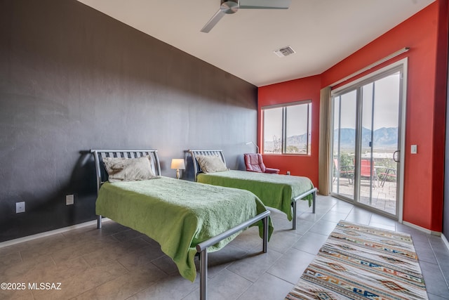 bedroom with access to outside, a mountain view, and ceiling fan