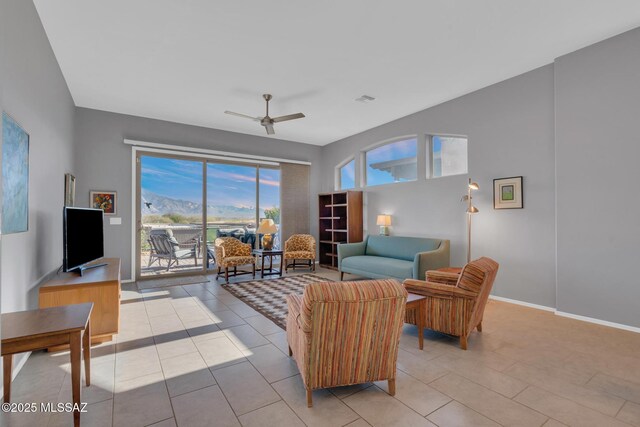 living room featuring ceiling fan and light tile patterned floors