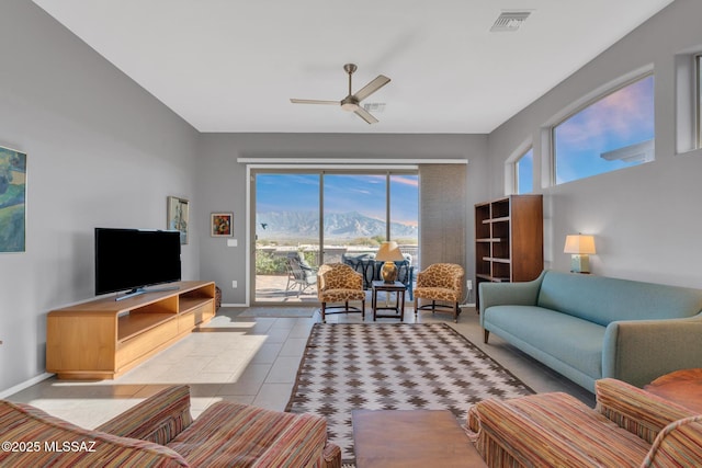 tiled living room featuring ceiling fan