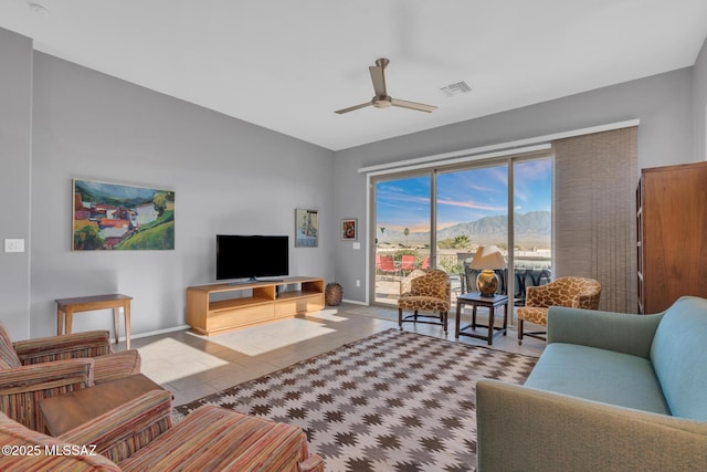 living room featuring ceiling fan and light tile patterned flooring