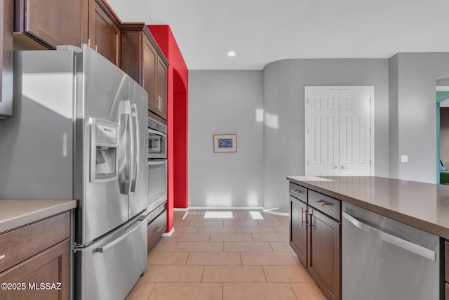 kitchen featuring appliances with stainless steel finishes and light tile patterned floors