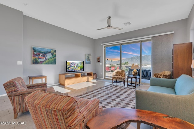 tiled living room with ceiling fan