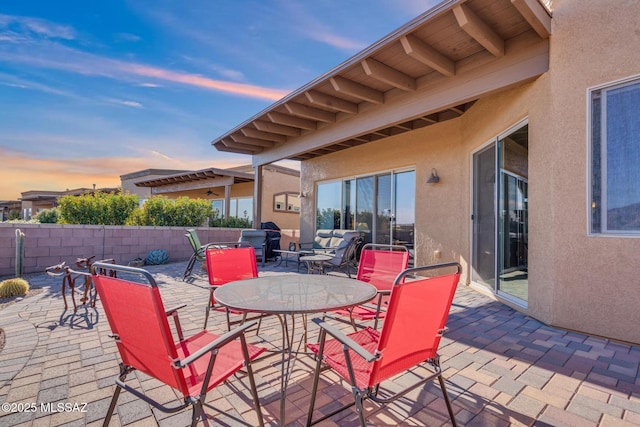 view of patio terrace at dusk