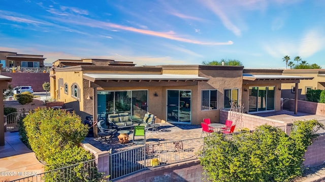 rear view of house featuring outdoor lounge area and a patio