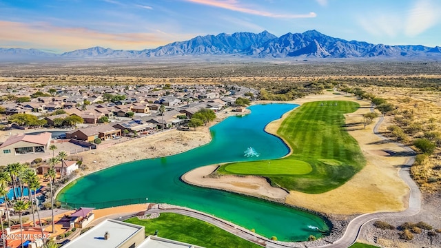 birds eye view of property with a water and mountain view