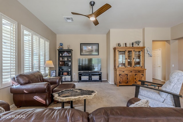 carpeted living room with ceiling fan