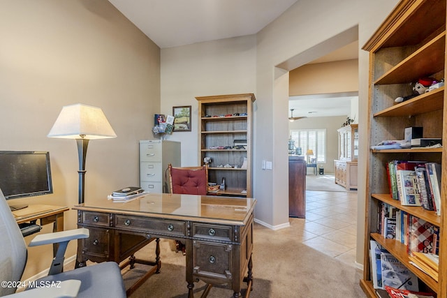 carpeted office space with ceiling fan