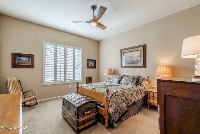 bedroom with ceiling fan and light colored carpet