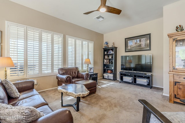 living room with ceiling fan, light colored carpet, and a wealth of natural light