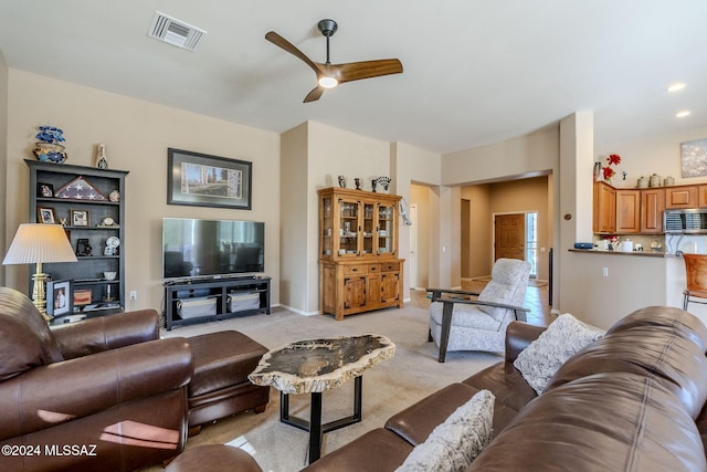 carpeted living room featuring ceiling fan