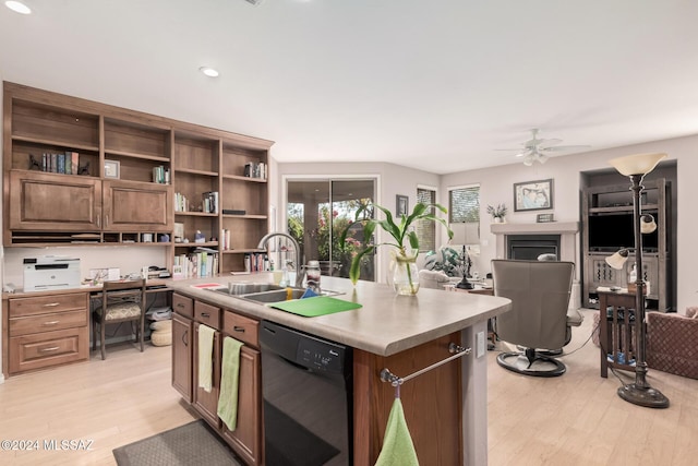 kitchen featuring dishwasher, a kitchen island with sink, sink, ceiling fan, and light hardwood / wood-style floors