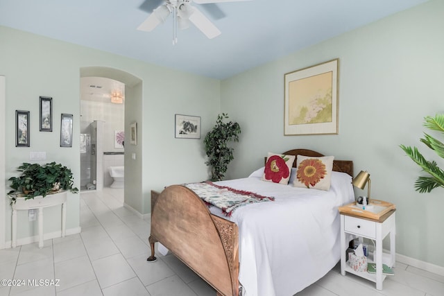 bedroom featuring ensuite bathroom, ceiling fan, and light tile patterned floors