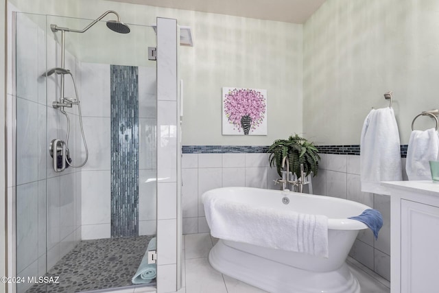 bathroom featuring vanity, separate shower and tub, and tile walls