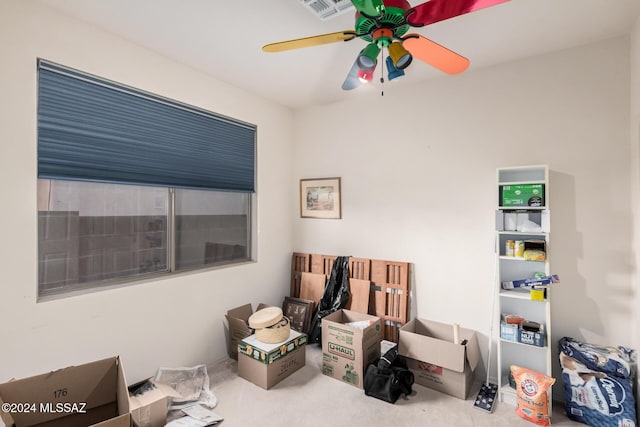 sitting room with ceiling fan and carpet