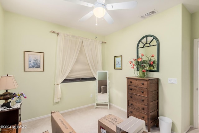 sitting room featuring ceiling fan and light carpet