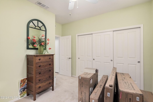 home office featuring light carpet and ceiling fan