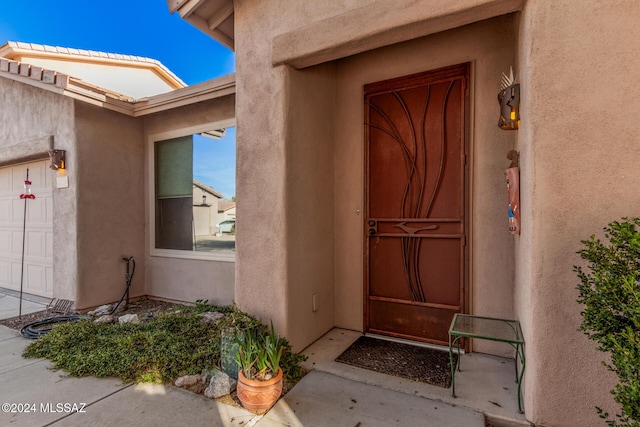 view of exterior entry featuring a garage