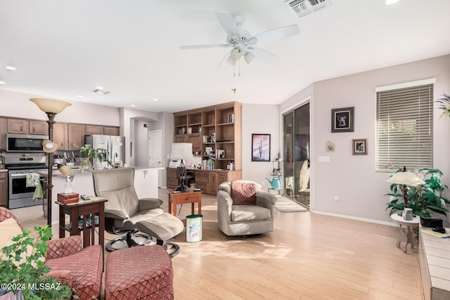 living room featuring light hardwood / wood-style floors and ceiling fan