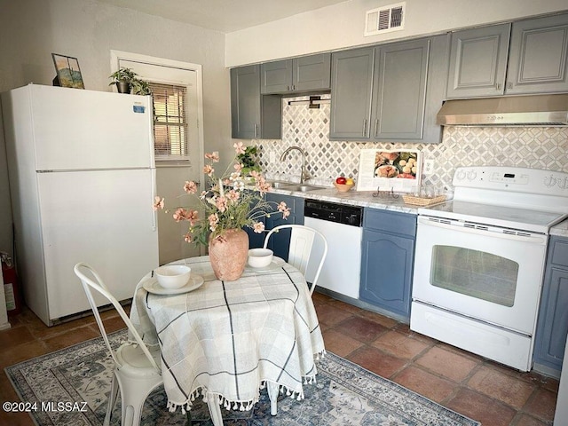 kitchen with sink, white appliances, and tasteful backsplash