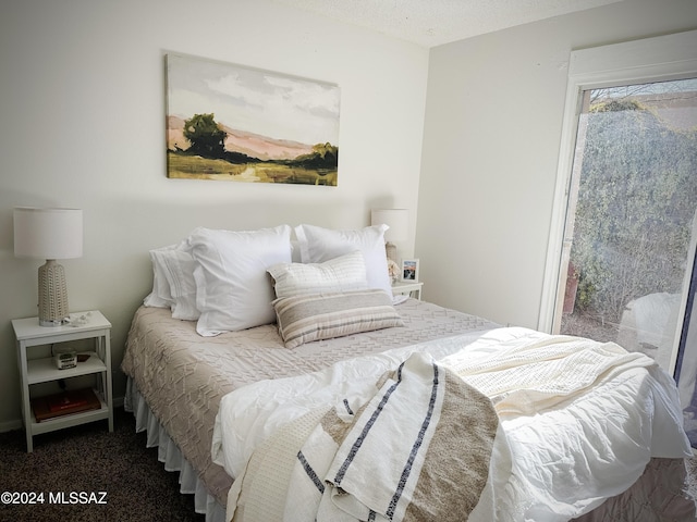 carpeted bedroom with a textured ceiling