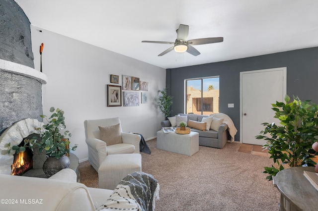 living room featuring a fireplace, ceiling fan, and carpet floors