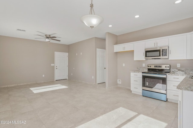 kitchen with white cabinets, decorative light fixtures, stainless steel appliances, and ceiling fan