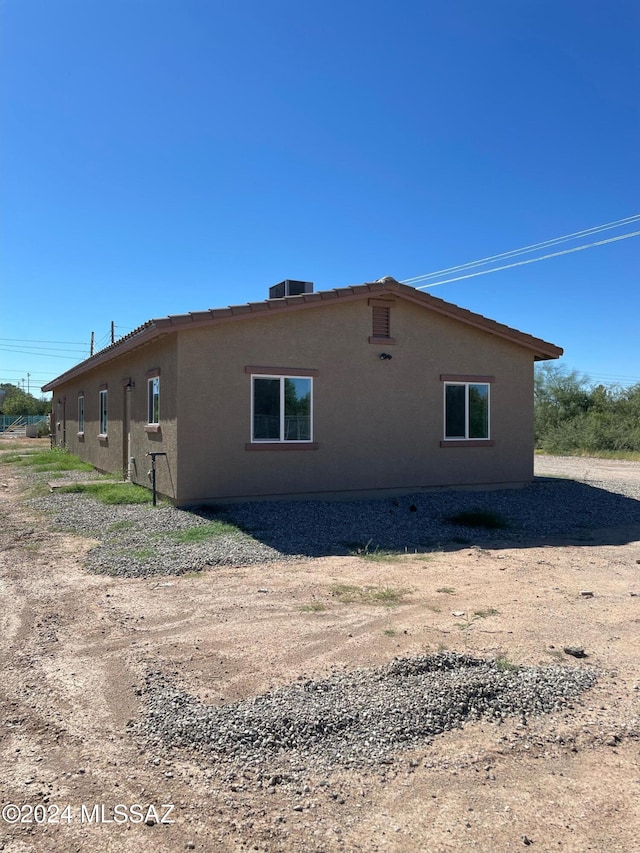 view of side of home featuring cooling unit