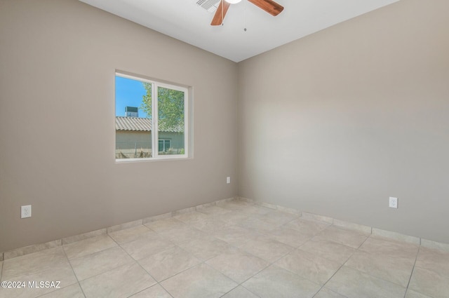 empty room with light tile patterned floors and ceiling fan